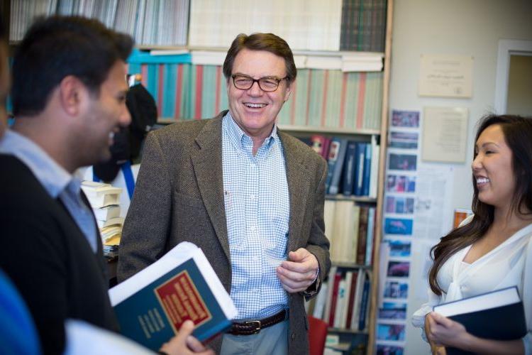 Stephen McCaffrey photographed smiling with law students.