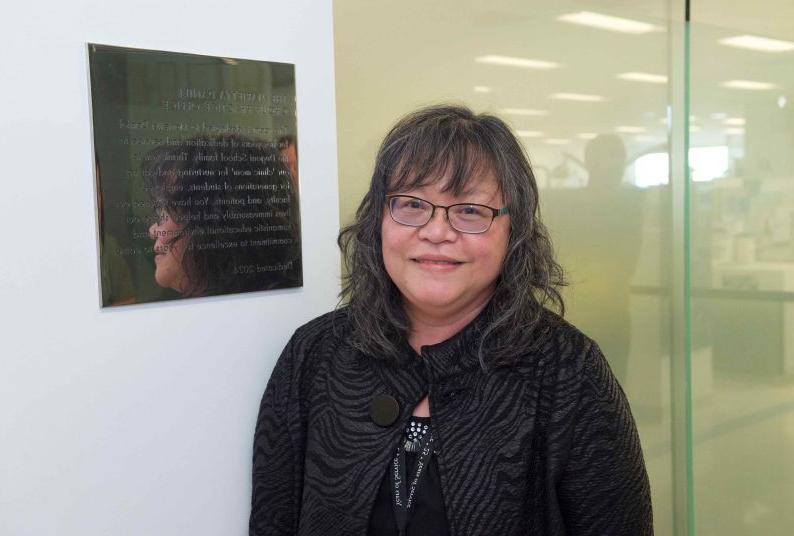 Marietta in front of her plaque