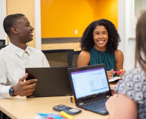 students sitting together smiling at each other